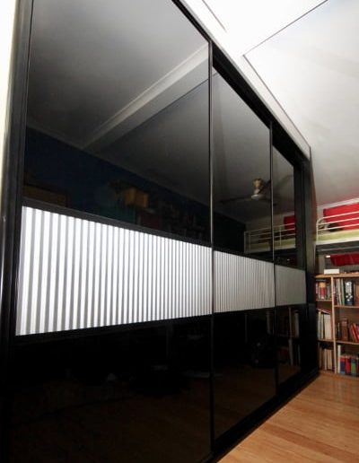 Black Sliding Cupboard Doors, Mini Orb Feature Panel. Rumpus Room