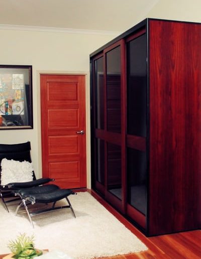 Built in timber sliding doors with black glass