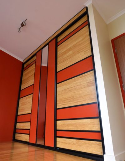Tropical Sliding Doors using left over floorboards and panels painted to match walls
