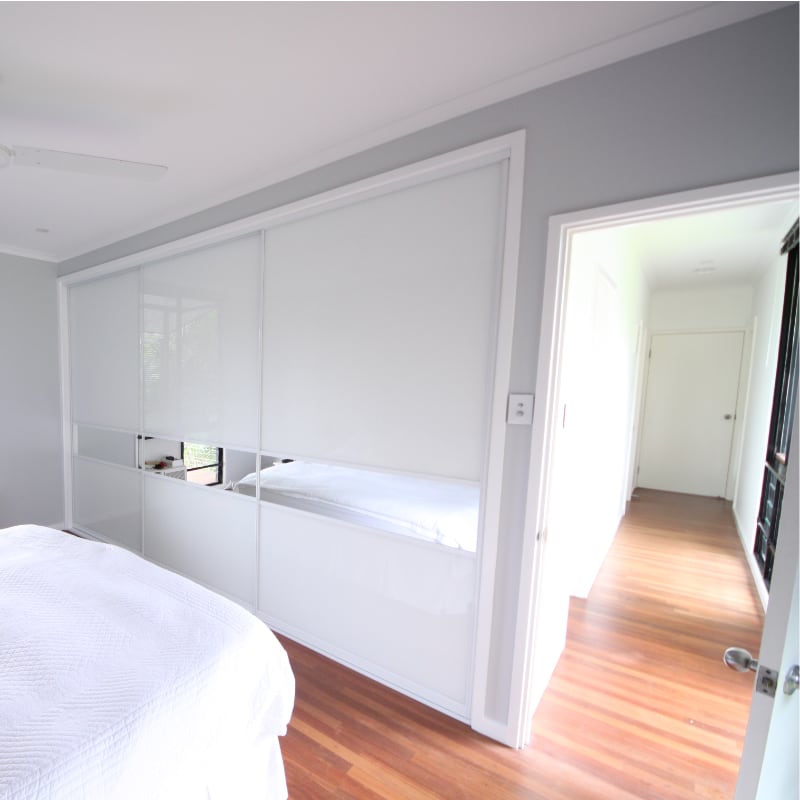Built In White Glass Wardrobe with Feature Horizontal Mirror