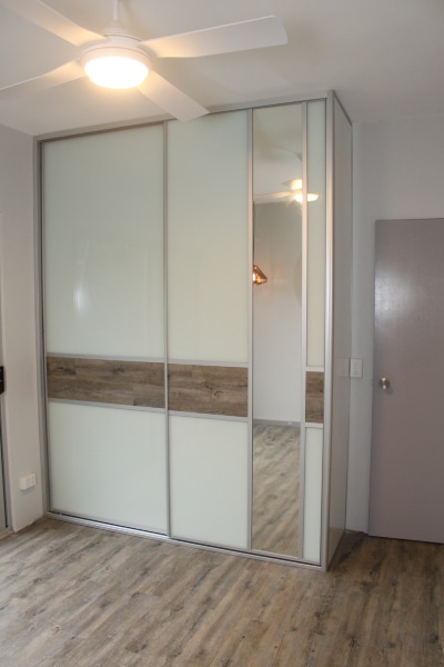 Built In Bedroom Cupboard.  Feature Panel Floating Timber Floorboards and Dress Mirror