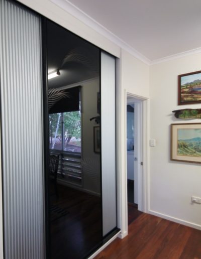 Built In Cupboard in Dining Room. Mini Orb & Black Glass. Black Glass has Palm Throng Design.
