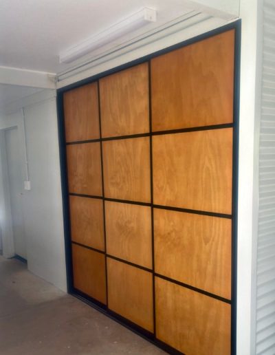 Laundry Sliding Door with Plywood Panels