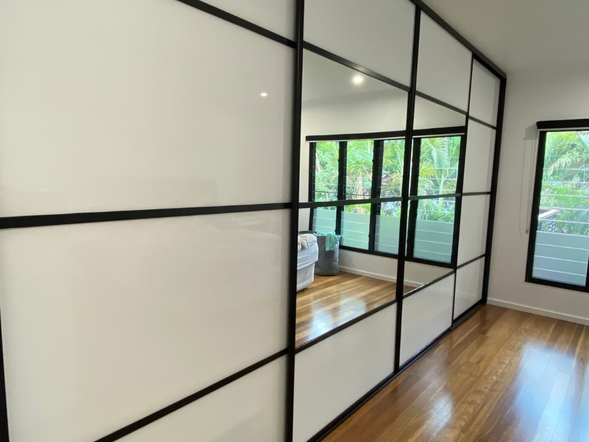 Custom Wardrobe- Sliding Doors with Mirror & White Glass Panels for a Distinctive Look