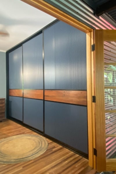 Mini Orb Sliding Wardrobe Doors featuring a horizontal timber panel