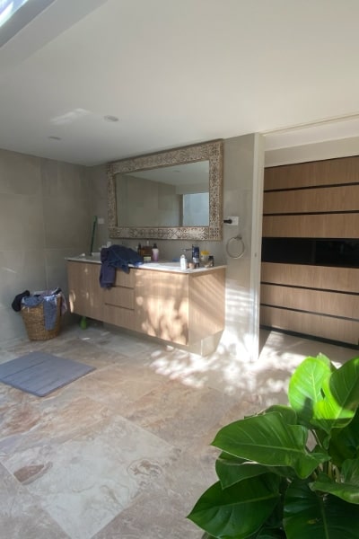 Outdoor Tropical Bathroom with Linen Cupboard Sliding Doors Intergration