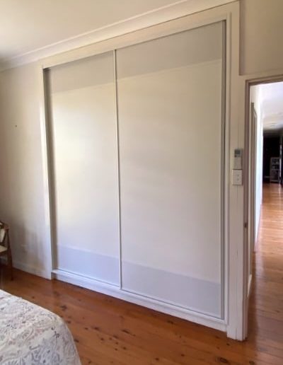 White sliding wardrobe doors with powder-coated white mesh panels