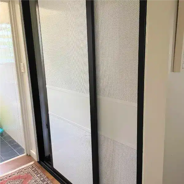 Hallway Cupboard with White Sliding Doors, Black Frames.  Panels are powder coated white frames to allow airflow in Tropical Home